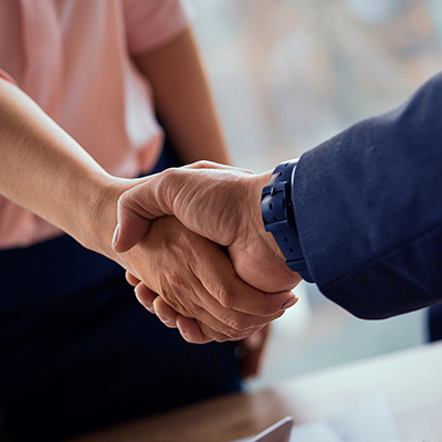 A man and woman shake hands