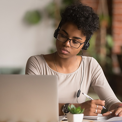 Woman watches a webinar on her laptop